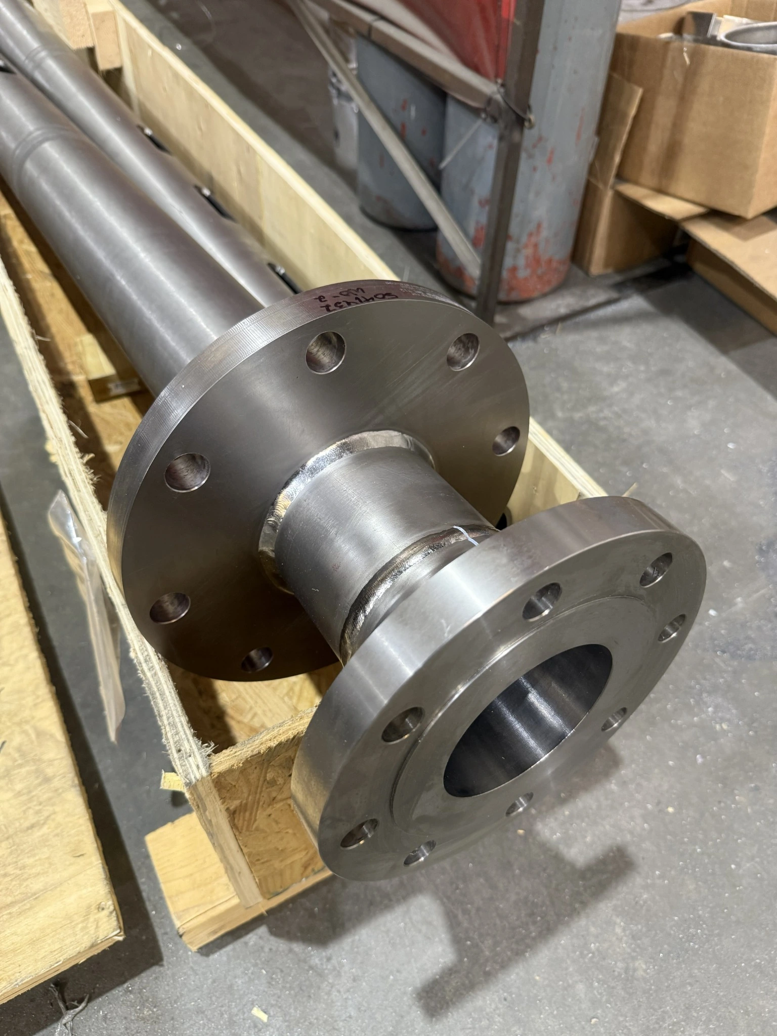 Completed pipe assembly with multiple flanges supported in a wooden crate