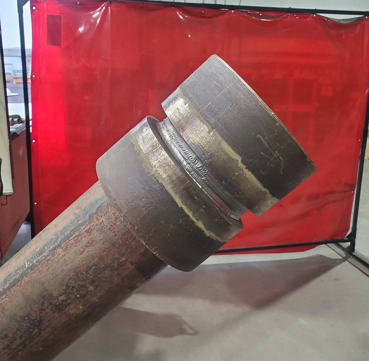 Welded pipe assembly with fittings and a coupling in a fabrication setting