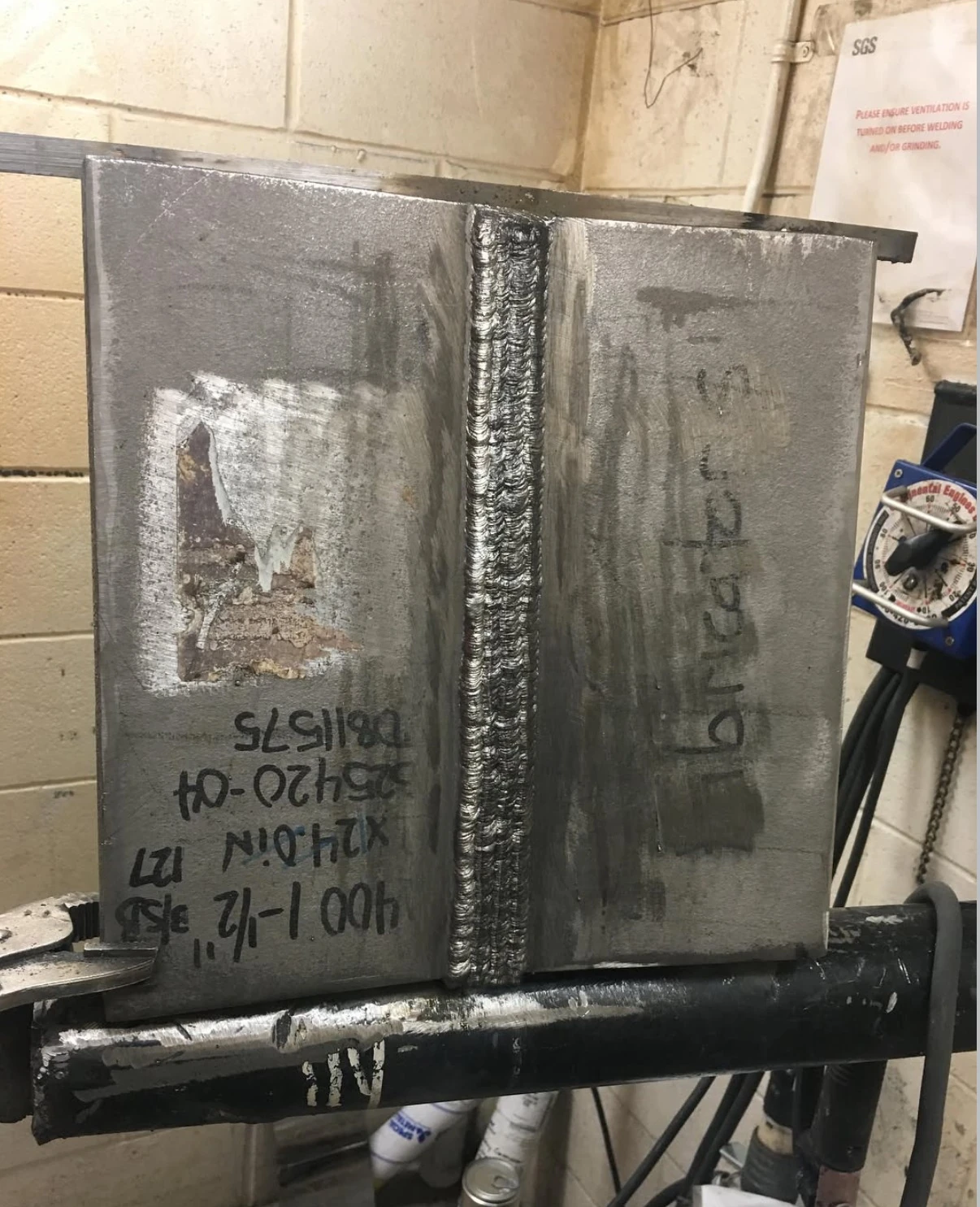 Completed vertical plate weld in a test setup