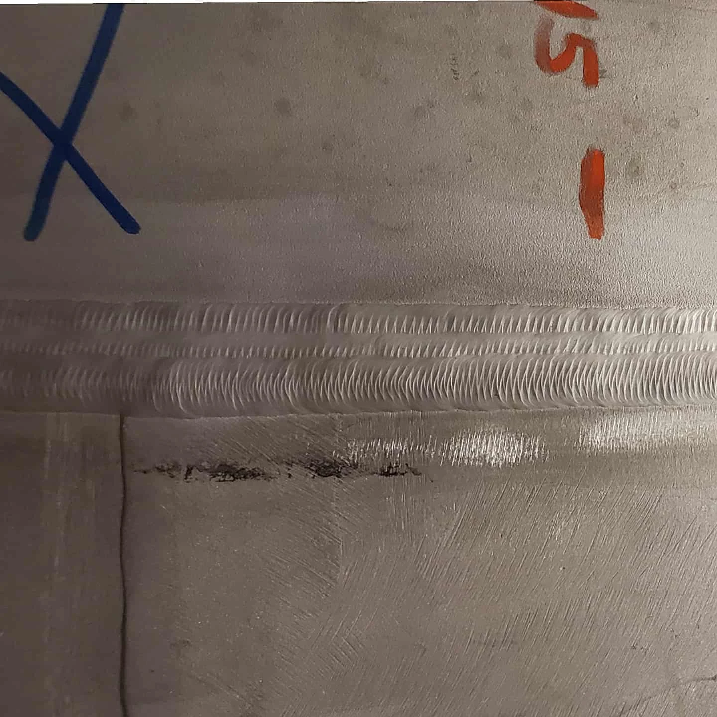 Close view of a multi-pass weld on large-diameter stainless steel pipe