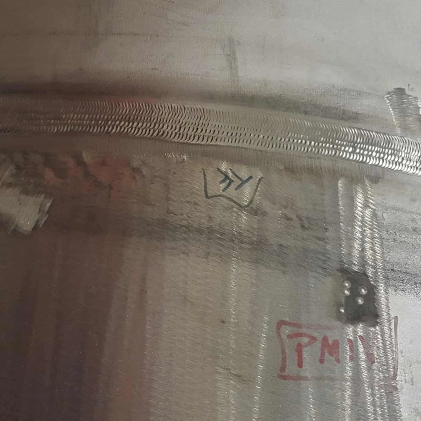 Completed multi-pass weld around a 42-inch stainless steel pipe